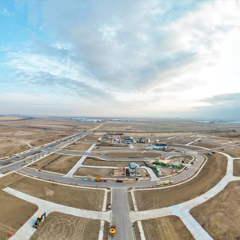Aerial view of homes under construction and cleared land.